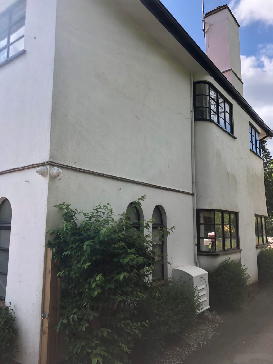 Rendered house before blast cleaning, with paint still on the walls