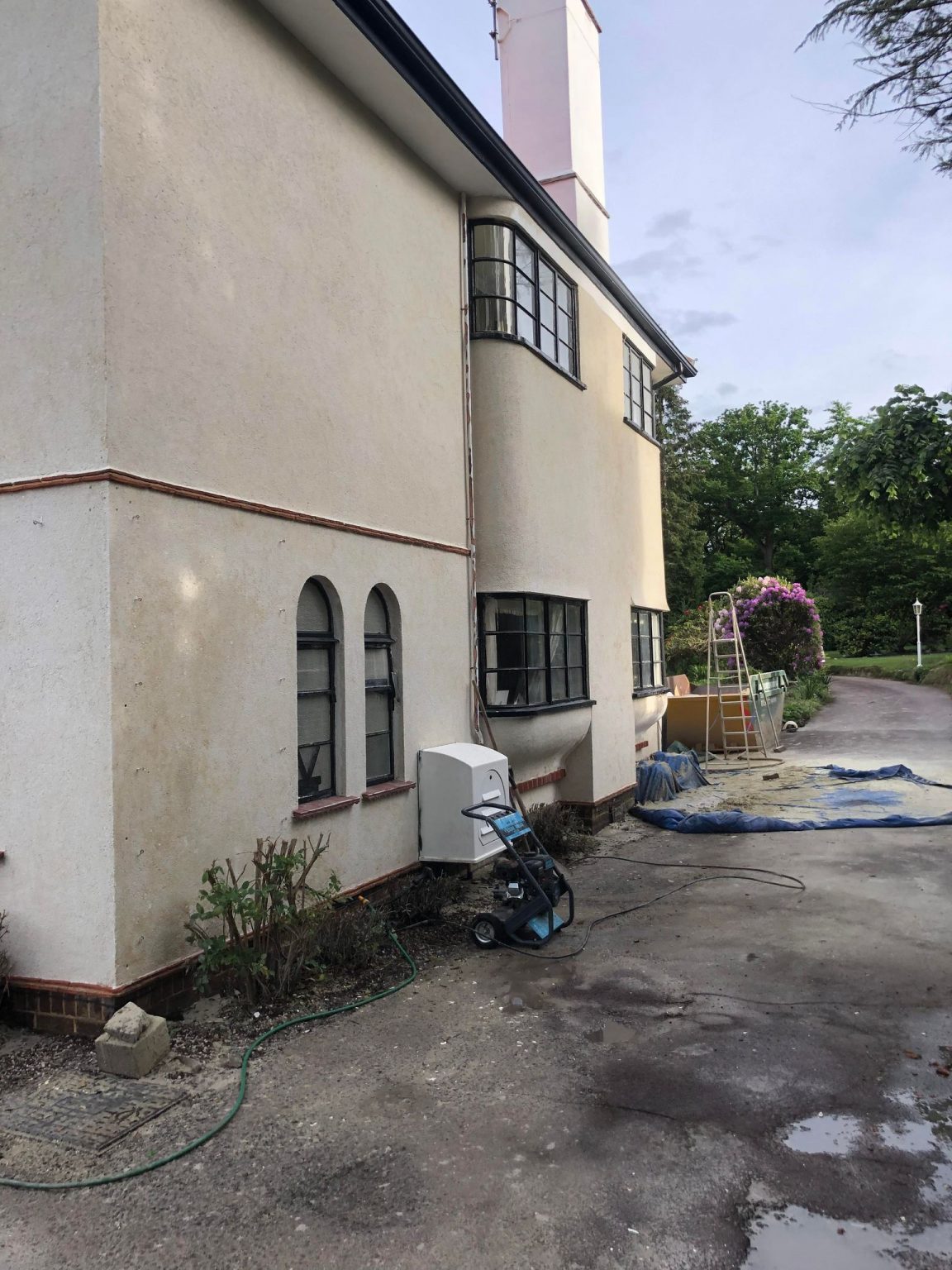 Rendered house after blast cleaning, paint removed from the render