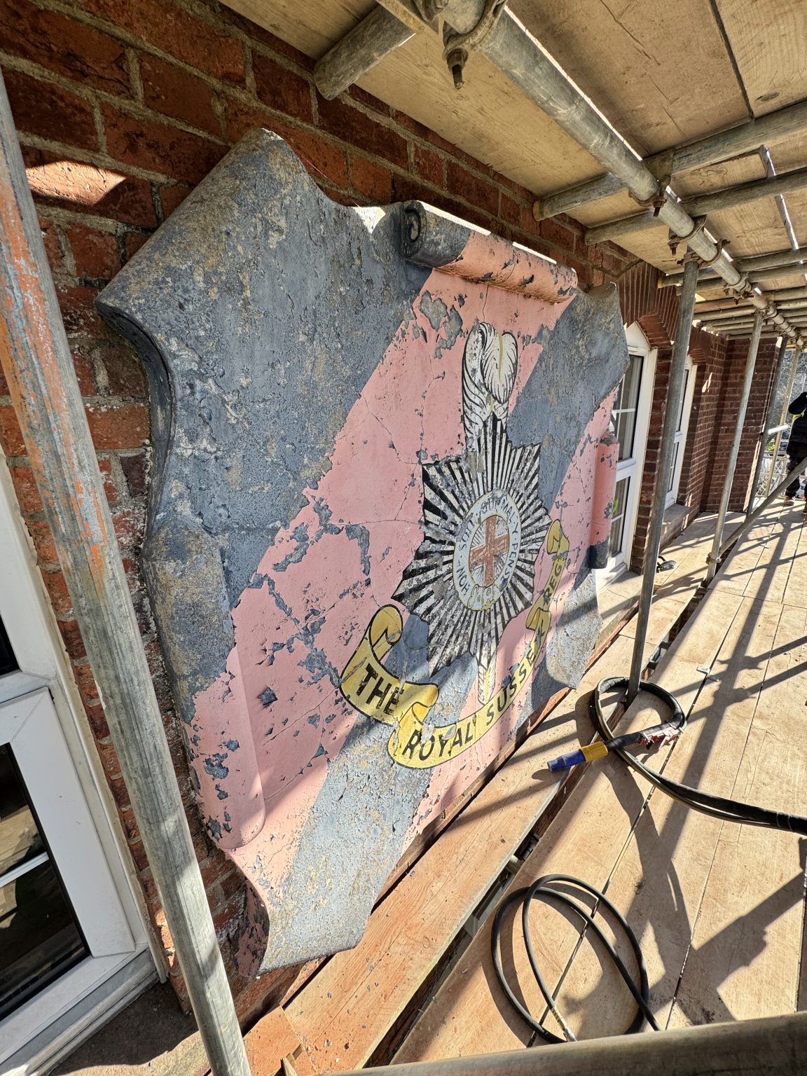 Painted badge at Bexhill Army Cadets before blast cleaning