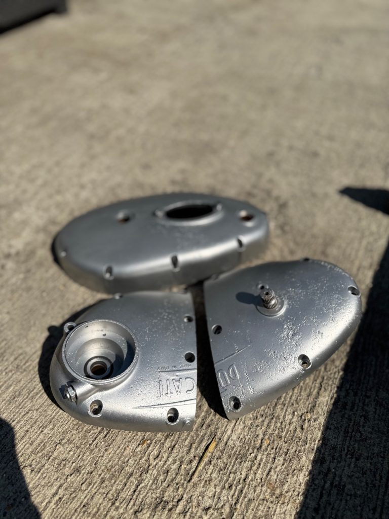 Rust-covered engine side covers restored with vapour blasting to reveal clean, textured aluminium.