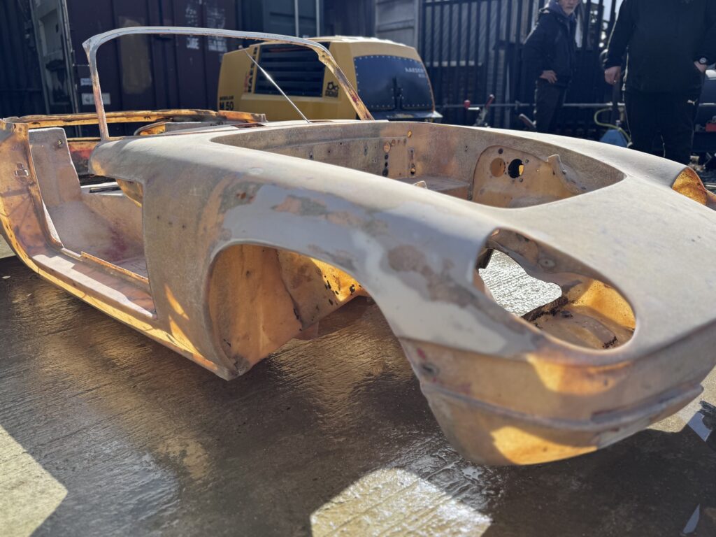 Lotus Elan convertible shell after soda blasting, front quarter