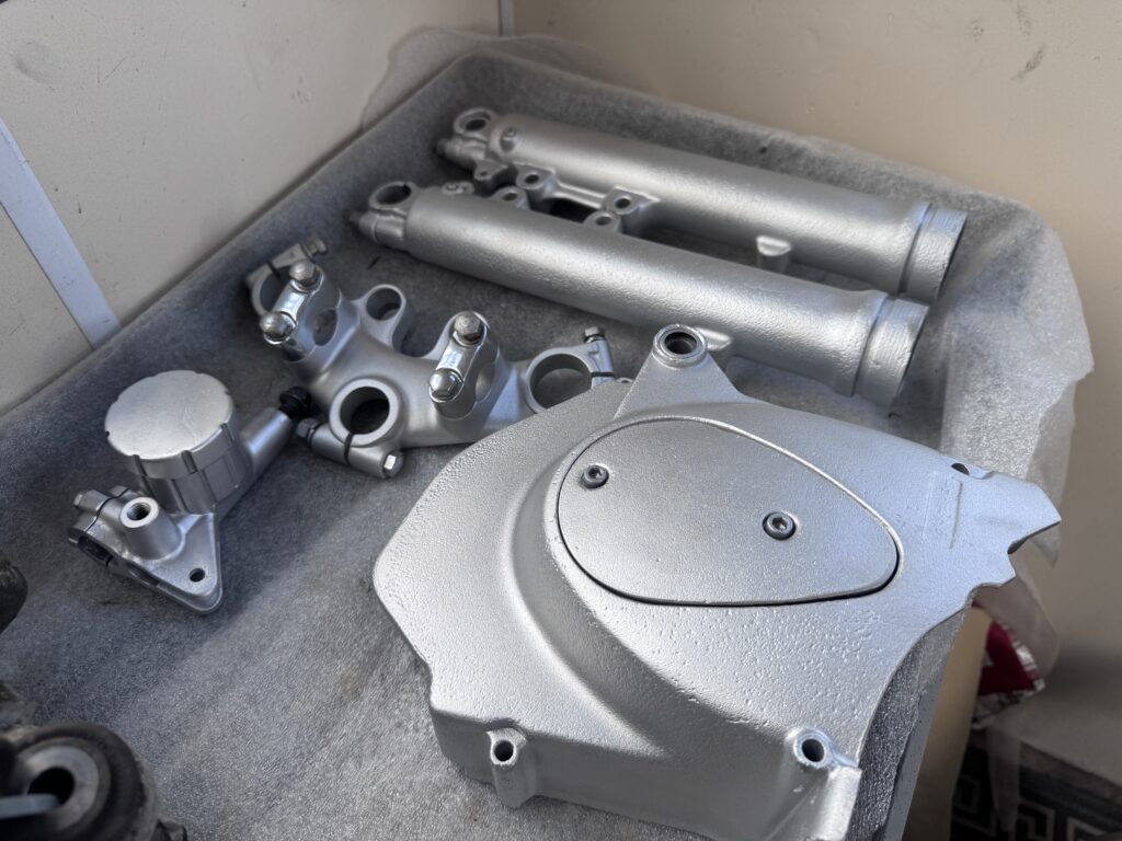Vapour blasted motorcycle forks and engine cover