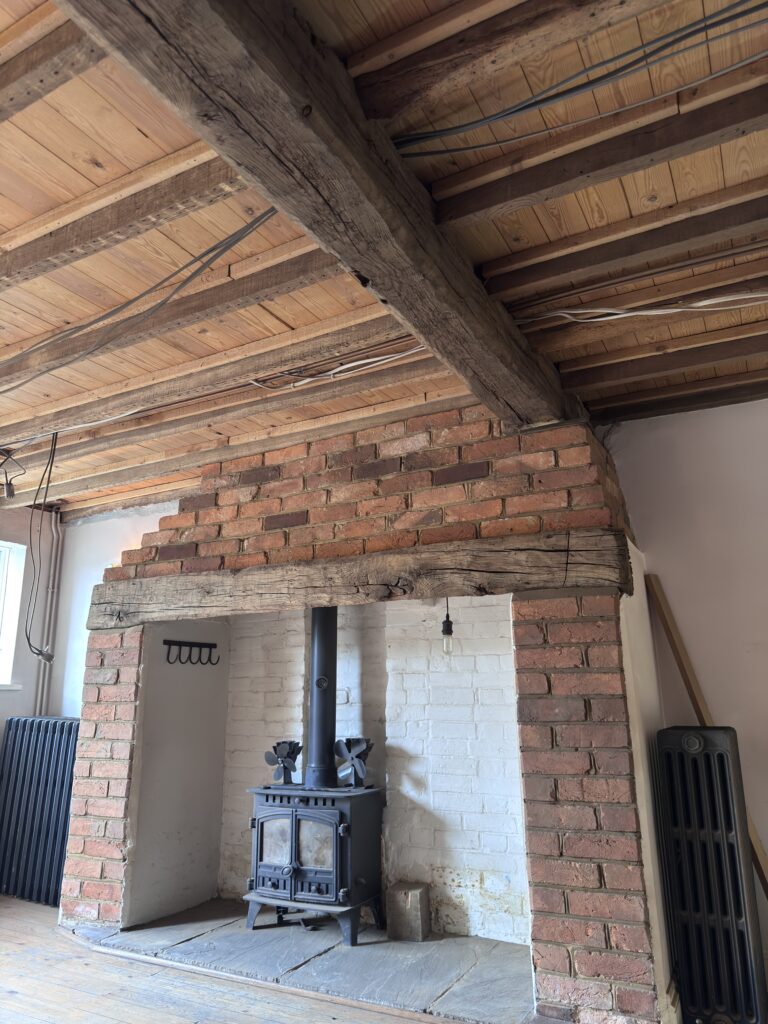 Oak beams and brick fireplace after blasting